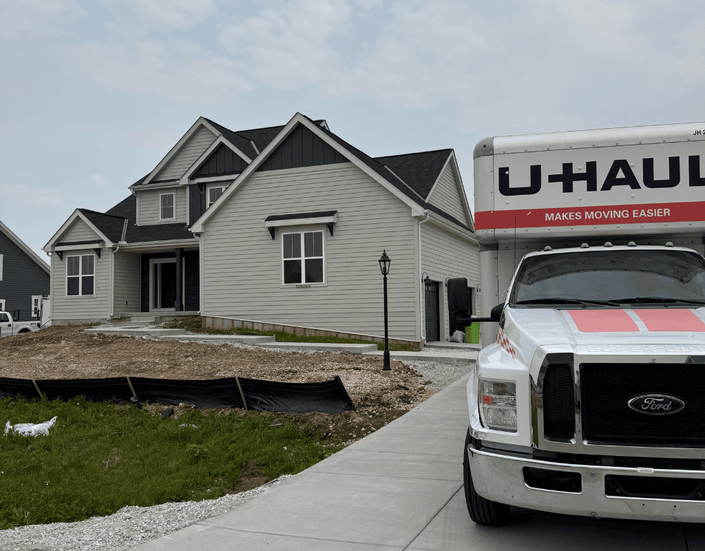 Haul Stars Moving truck parked next to a portable container outside a Milwaukee house for pickup