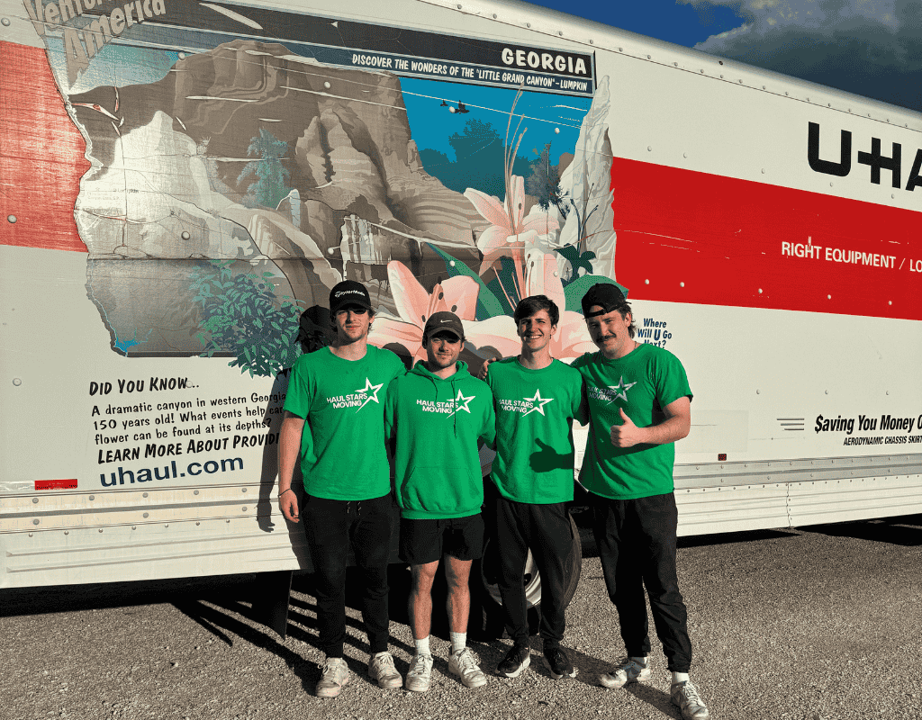 Moving crew standing in front of a PODS container in Milwaukee ready to load belongings